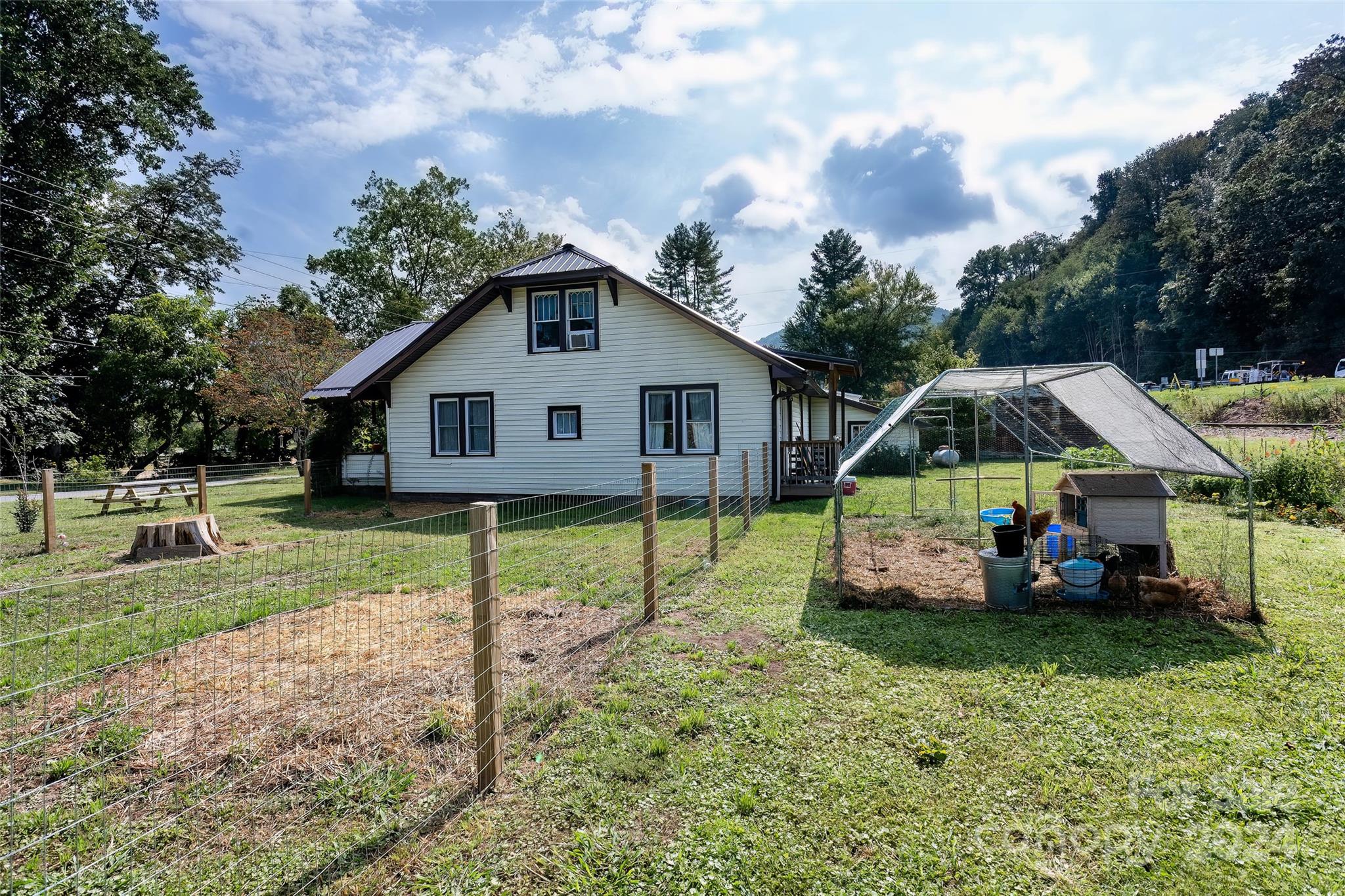 3786 Broad Street Clyde, NC 28721 - Photo 41 of 48 a front view of a house with garden
