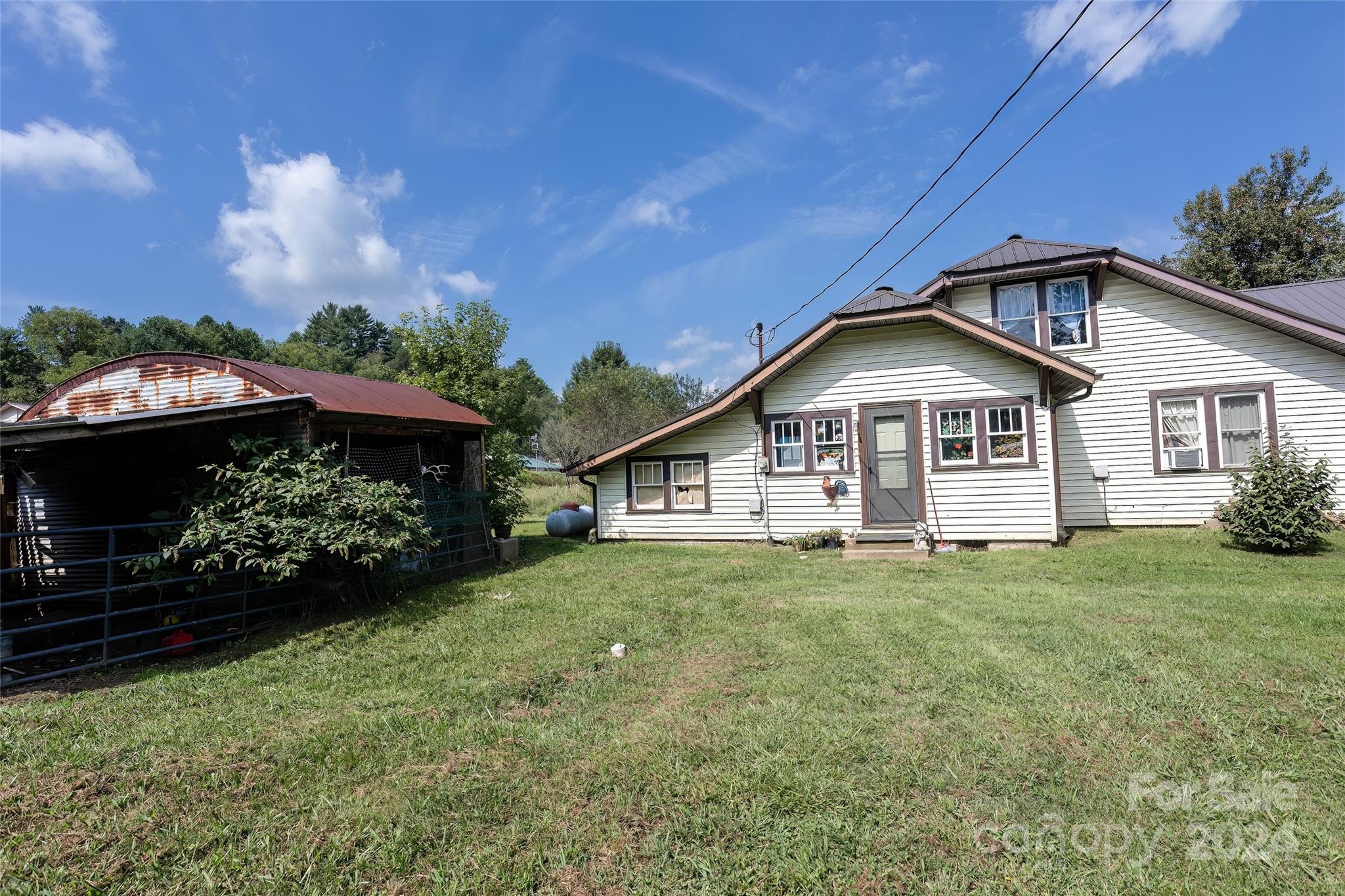 3786 Broad Street Clyde, NC 28721 - Photo 45 of 48 a view of a house with a yard