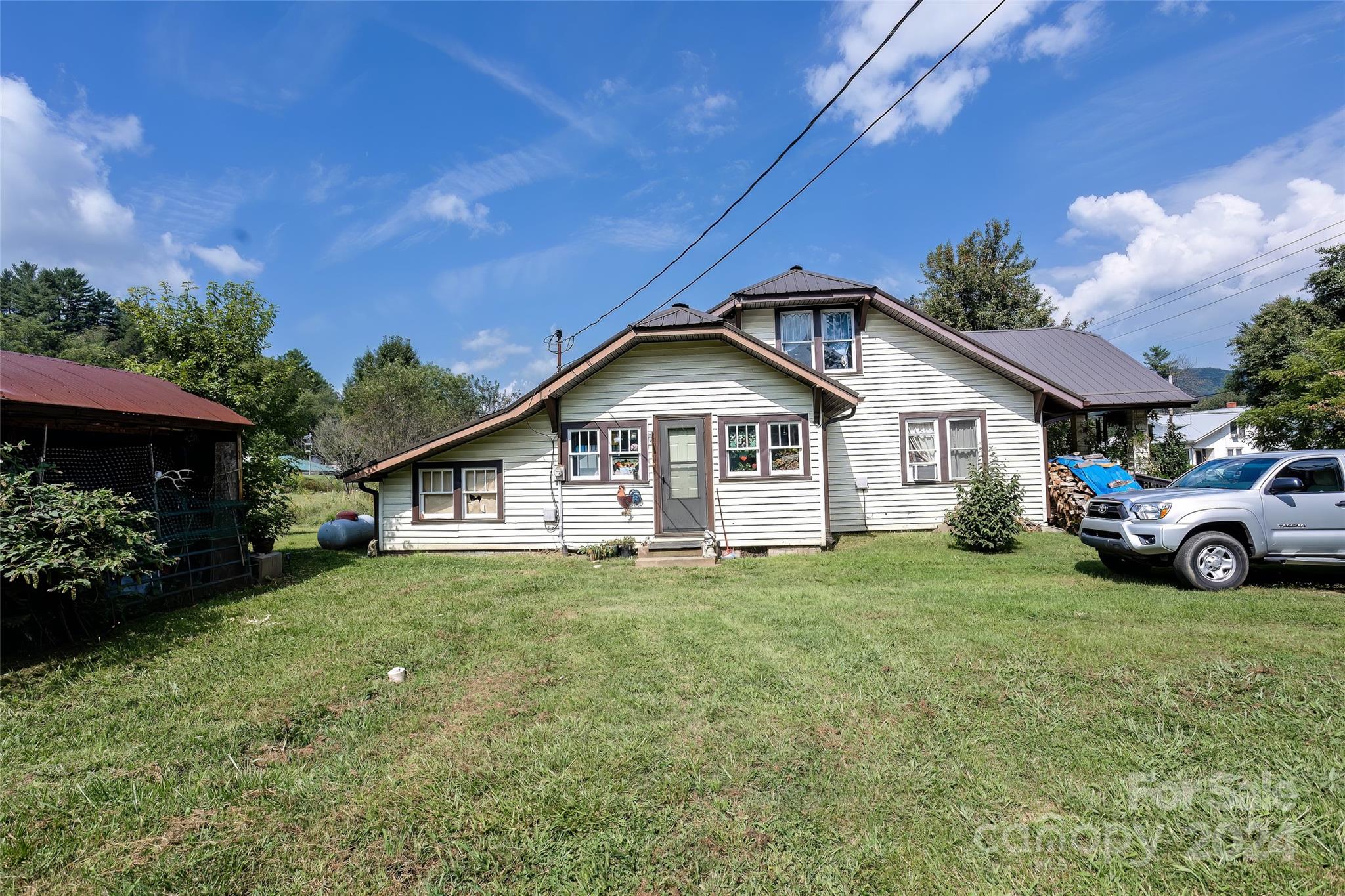 3786 Broad Street Clyde, NC 28721 - Photo 46 of 48 a view of a house with a yard