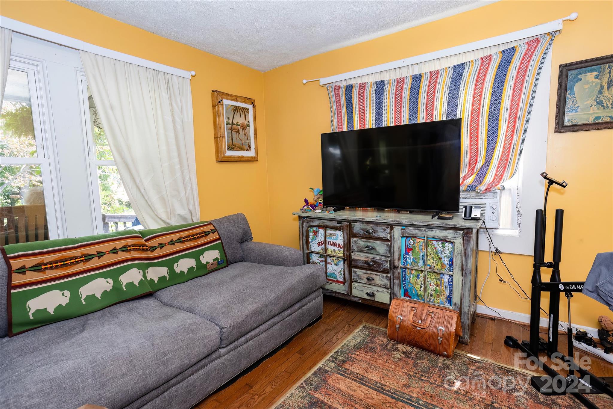 3786 Broad Street Clyde, NC 28721 - Photo 7 of 48 a living room with furniture and a flat screen tv