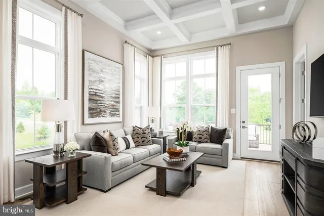 a living room with furniture and large windows