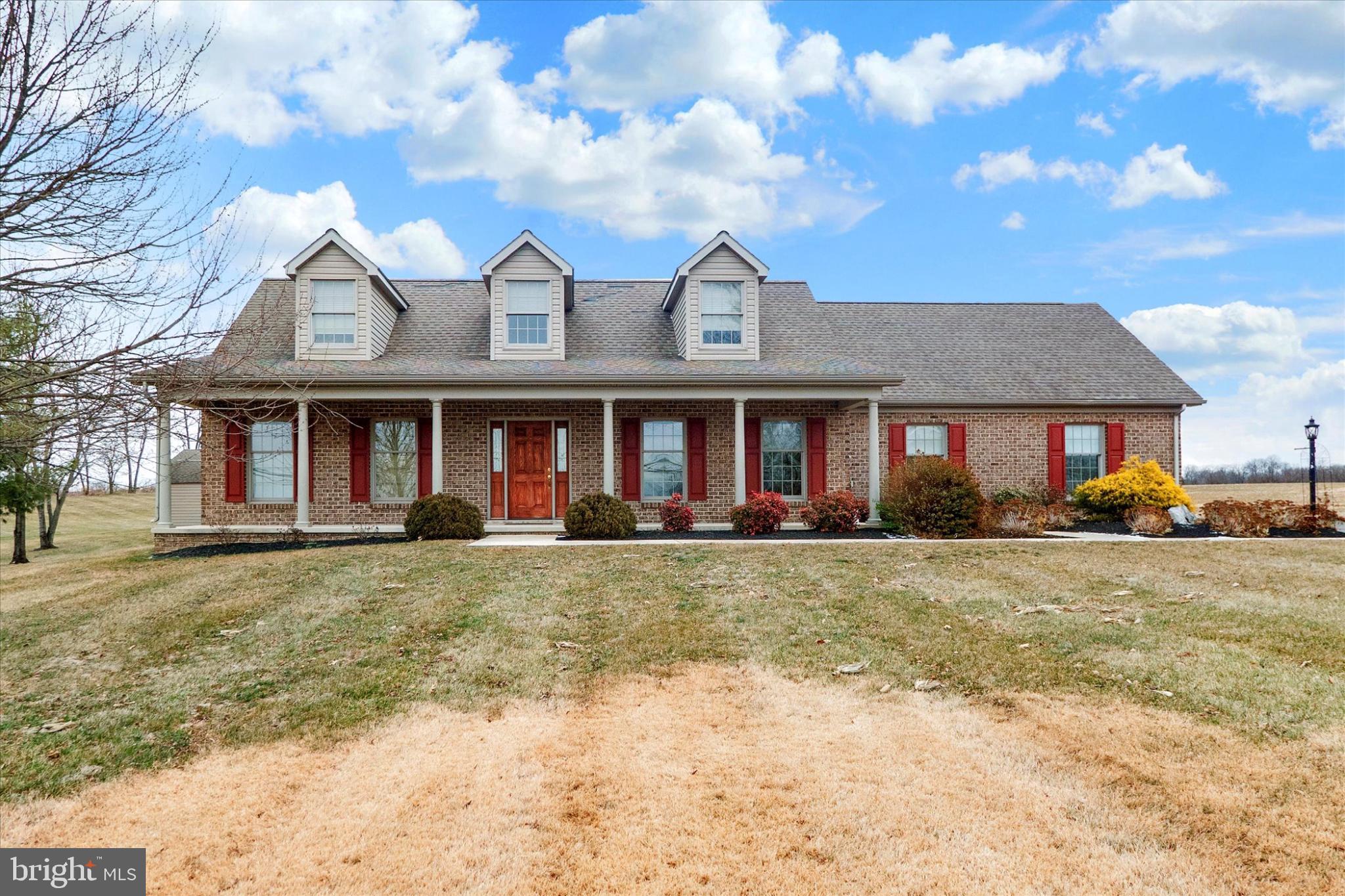 front view of a brick house with a yard