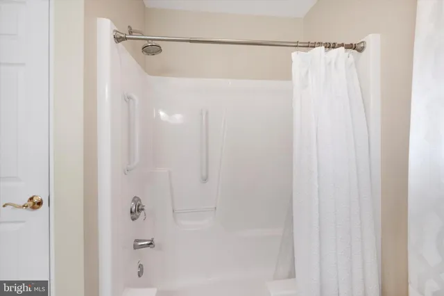 a bathroom with a shower and a tub