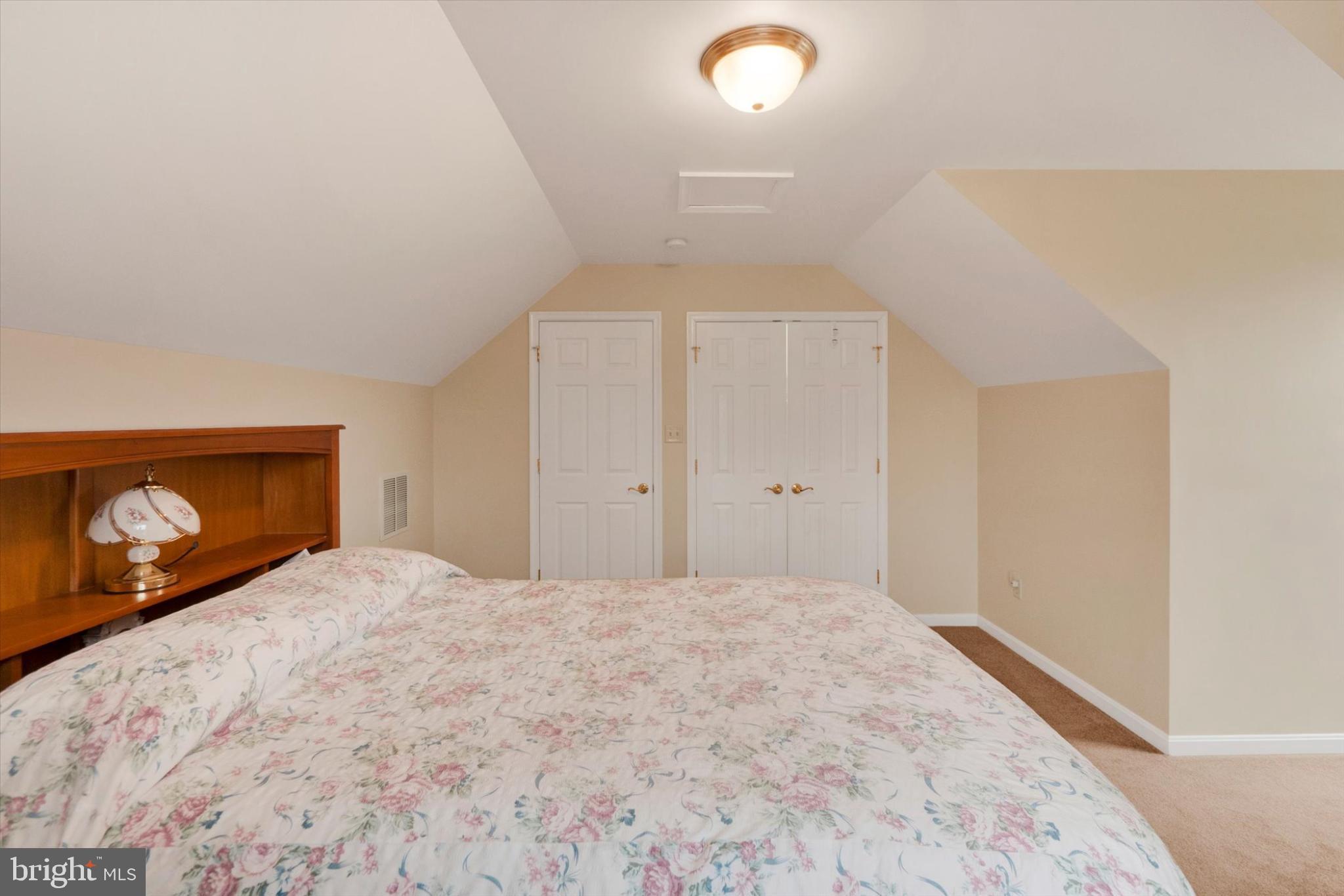 13323 Maugansville Road Hagerstown, MD 21740 - Photo 16 of 27 a bedroom with a bed and a lamp on dresser
