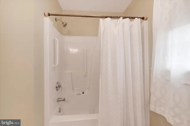 a bathroom with a shower and a tub