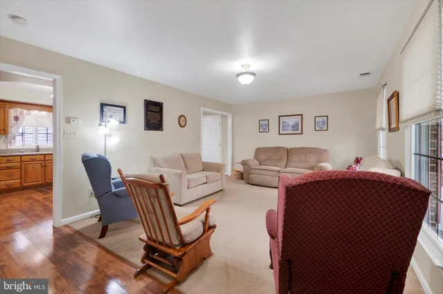 a living room with furniture a window and a flat screen tv