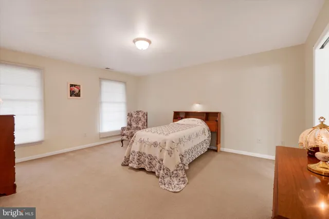 a spacious bedroom with a bed and a cabinets