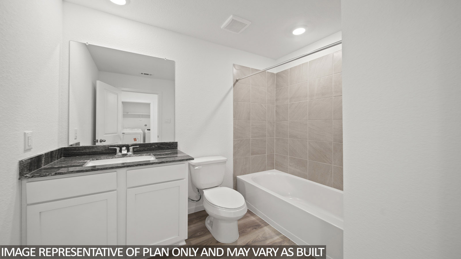 220 Flying Tigers Trail Jarrell, TX 76537 - Photo 19 of 21 Bathroom featuring a white vanity with a dark speckled countertop, undermount sink, and a large wall-mounted mirror
