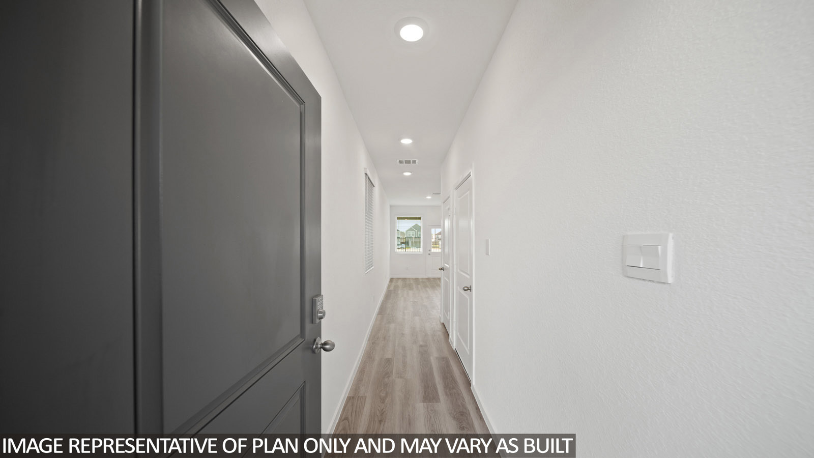 220 Flying Tigers Trail Jarrell, TX 76537 - Photo 2 of 21 Entryway featuring a dark gray paneled door, light wood-finish flooring, recessed lighting, and white textured walls