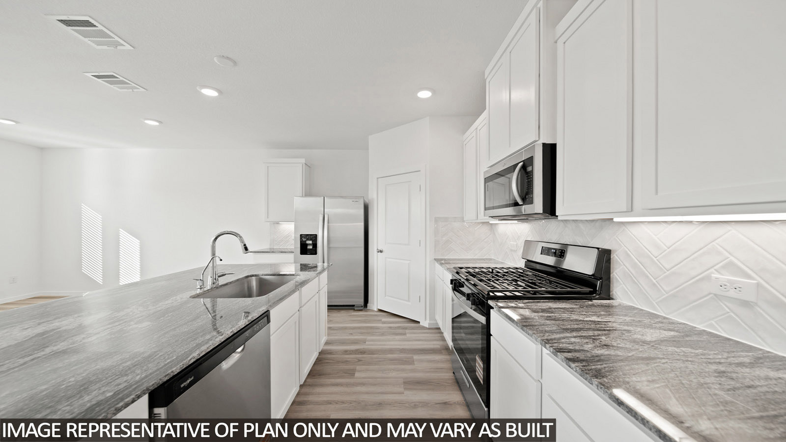 220 Flying Tigers Trail Jarrell, TX 76537 - Photo 3 of 21 Kitchen featuring stone countertops, stainless steel appliances, white cabinetry, wood-finish flooring, and a herringbone tile backsplash