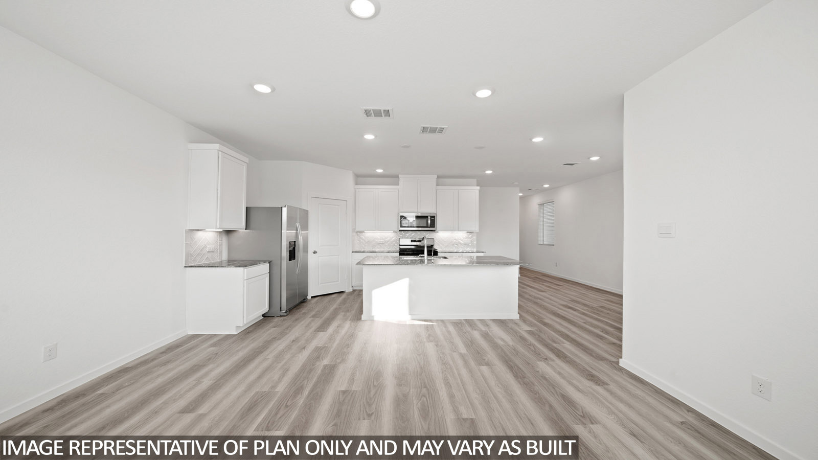 220 Flying Tigers Trail Jarrell, TX 76537 - Photo 9 of 21 Open-concept kitchen and living area featuring wood-finish flooring, recessed lighting, and white cabinetry