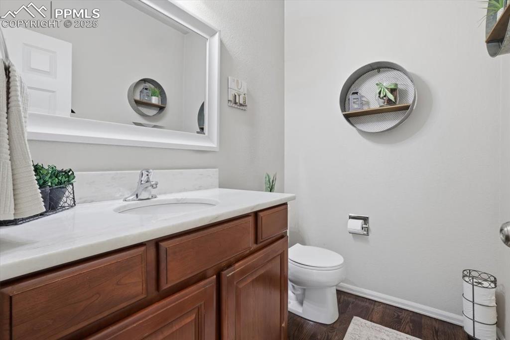 12114 Sleeping Bear Road Peyton, CO 80831 - Photo 15 of 47 a bathroom with a toilet a sink and mirror