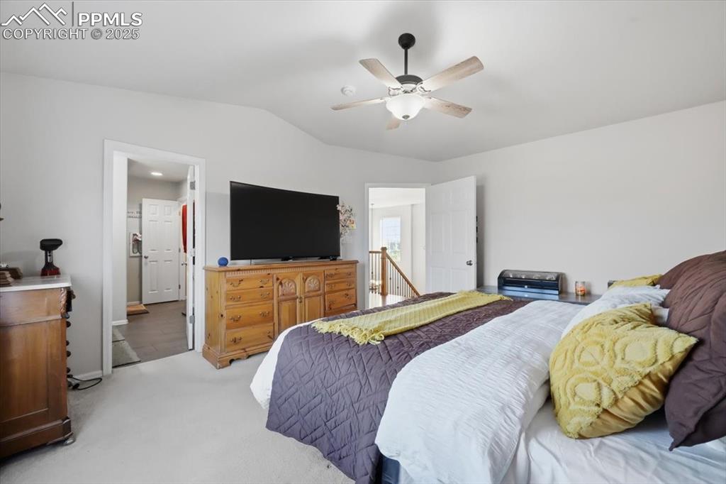 12114 Sleeping Bear Road Peyton, CO 80831 - Photo 21 of 47 a bedroom with two beds and a flat screen tv