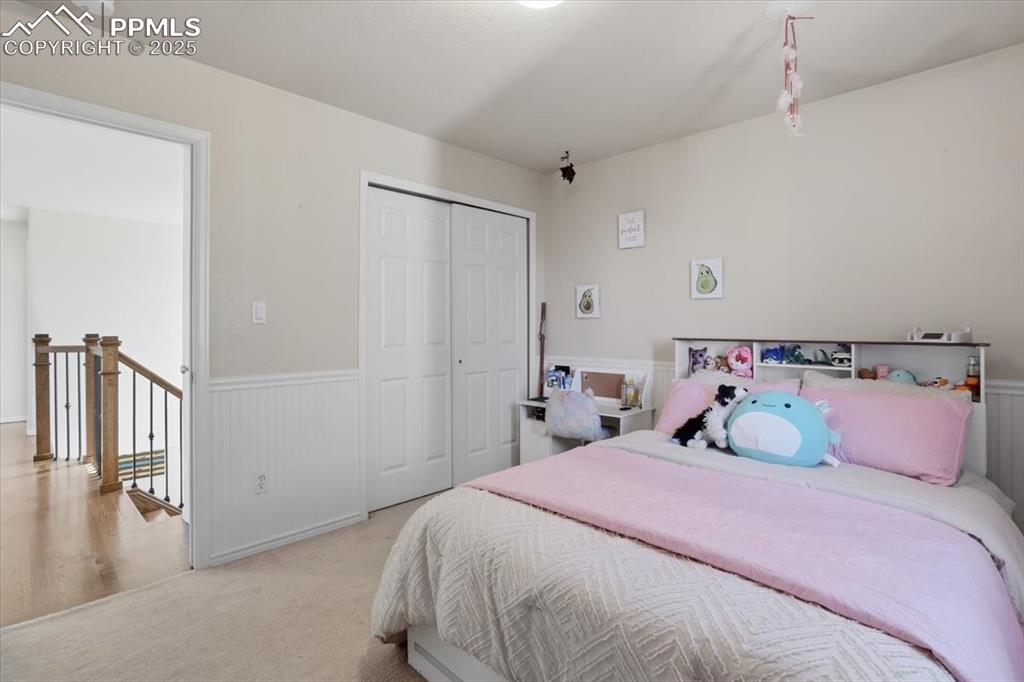 12114 Sleeping Bear Road Peyton, CO 80831 - Photo 25 of 47 a bedroom with a bed and a refrigerator