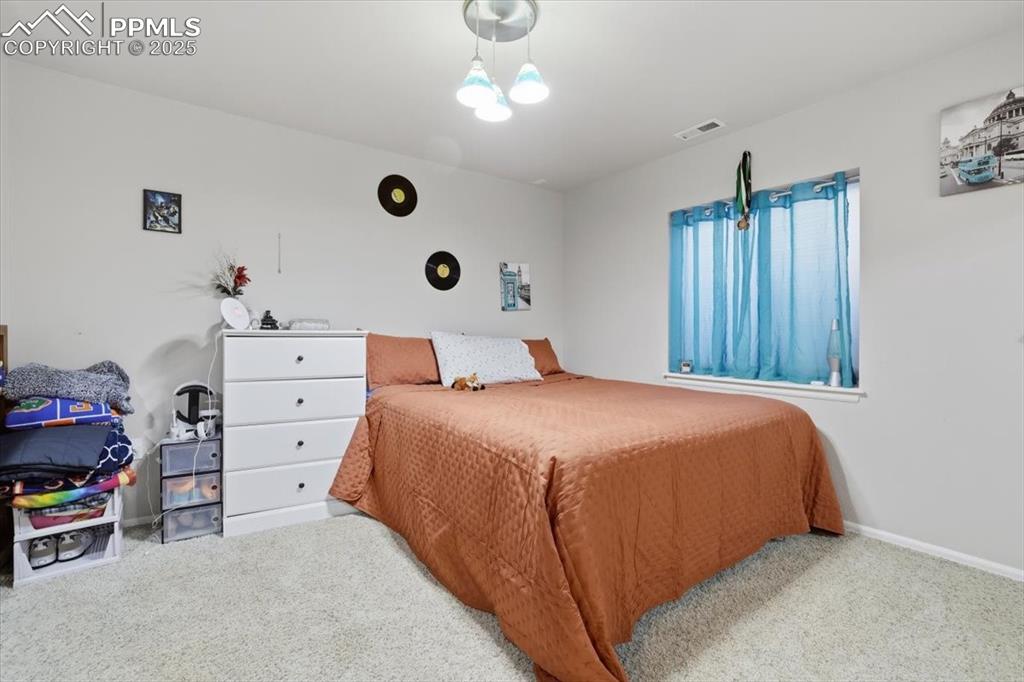 12114 Sleeping Bear Road Peyton, CO 80831 - Photo 33 of 47 a bedroom with a bed and a cabinets