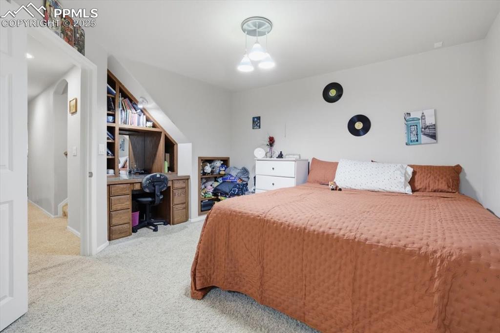 12114 Sleeping Bear Road Peyton, CO 80831 - Photo 34 of 47 a bed room with a bed and a television