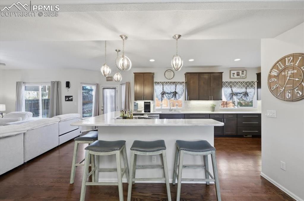 12114 Sleeping Bear Road Peyton, CO 80831 - Photo 9 of 47 a large kitchen with a table and chairs