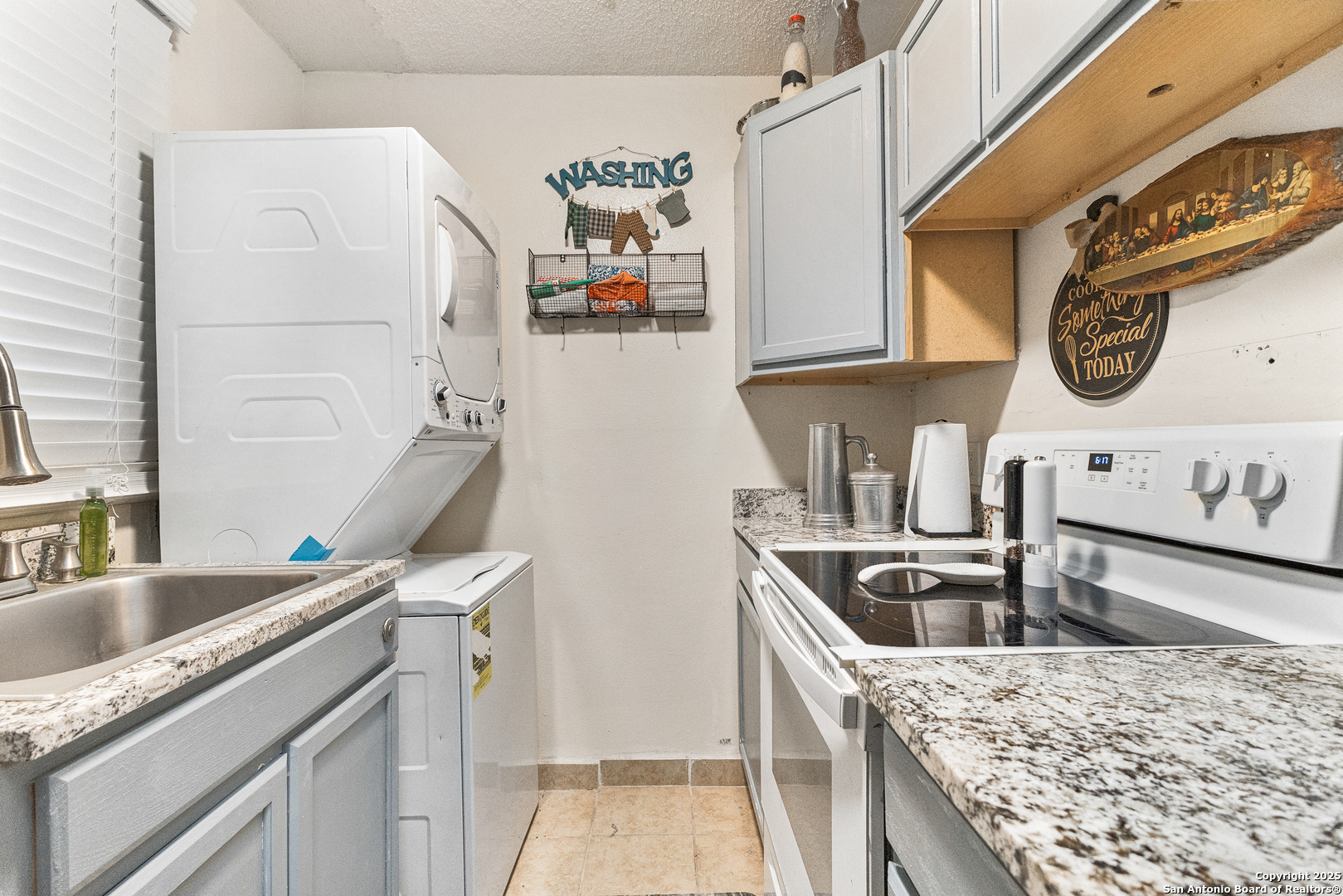 911 Vance Jackson Road, Unit 211 San Antonio, TX 78201 - Photo 4 of 8 a kitchen with stainless steel appliances granite countertop a sink and a stove