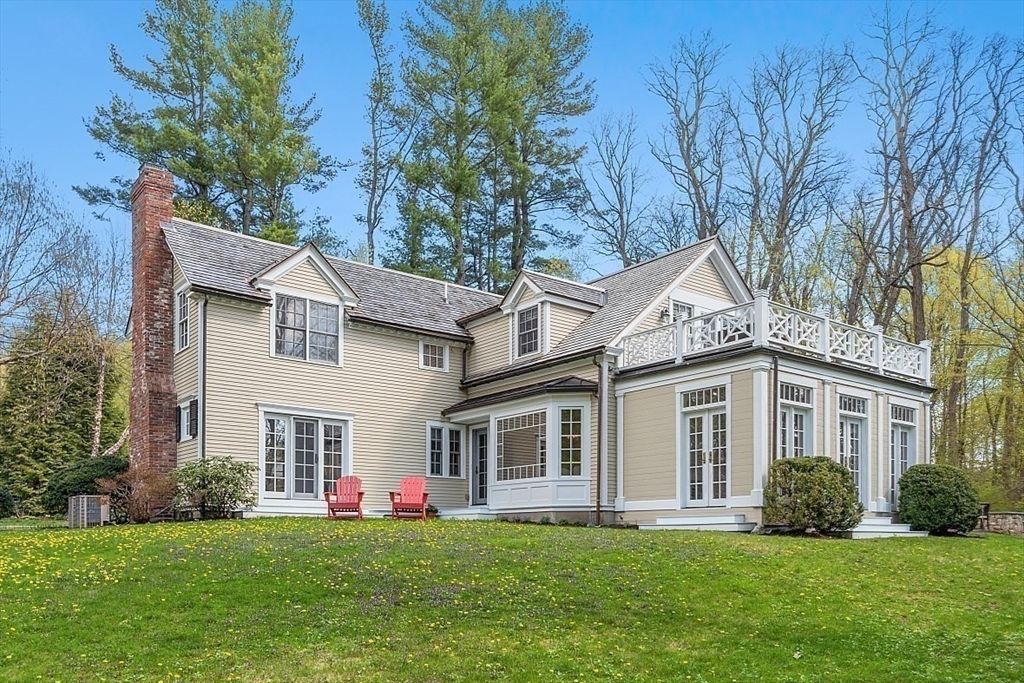 38 Ripley Hill Road Concord, MA 01742 - Photo 35 of 37 a front view of a house with a garden and trees
