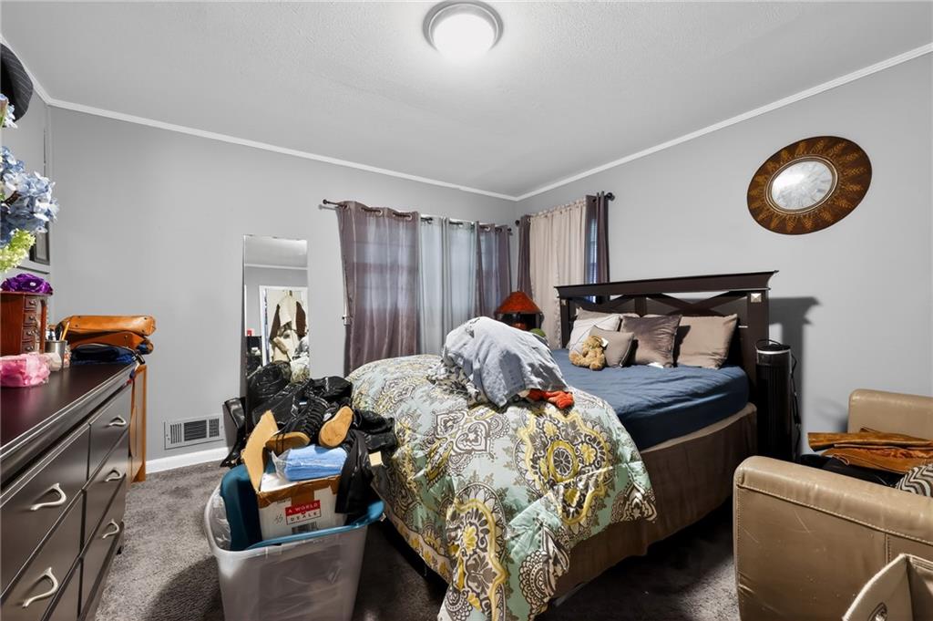 1819 Canterbury Road Macon, GA 31206 - Photo 12 of 15 a bedroom with bed and a chandelier