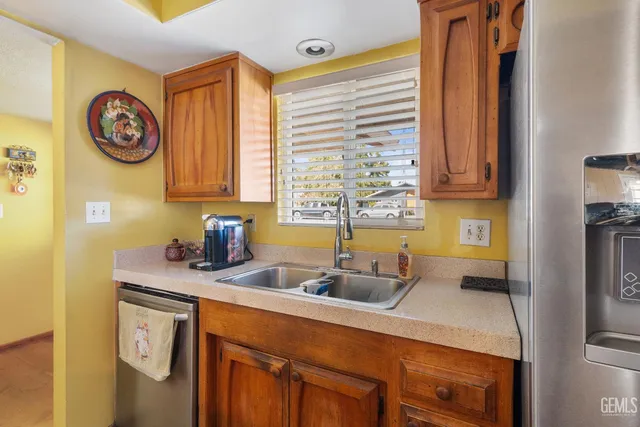 a kitchen with stainless steel appliances a sink a stove and a refrigerator