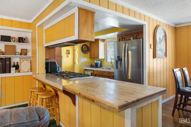 a kitchen with a table chairs and a refrigerator