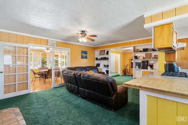 a living room with furniture and a floor to ceiling window