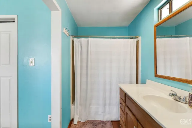 a bedroom with a bed and a ceiling fan