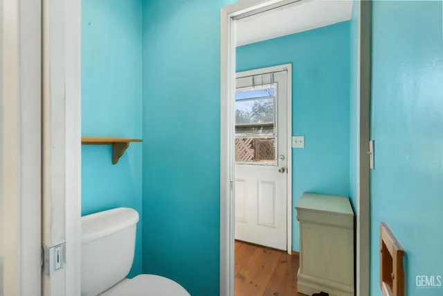 a bedroom with a bed and a dresser next to a window