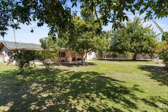 a backyard of a building with large trees