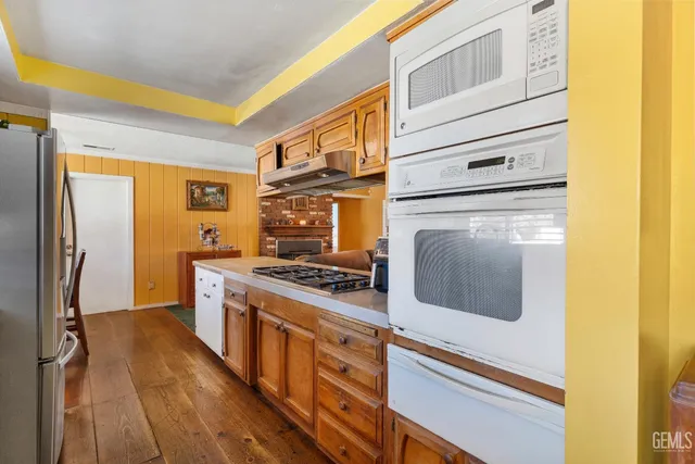 a kitchen with stainless steel appliances granite countertop a stove and a refrigerator