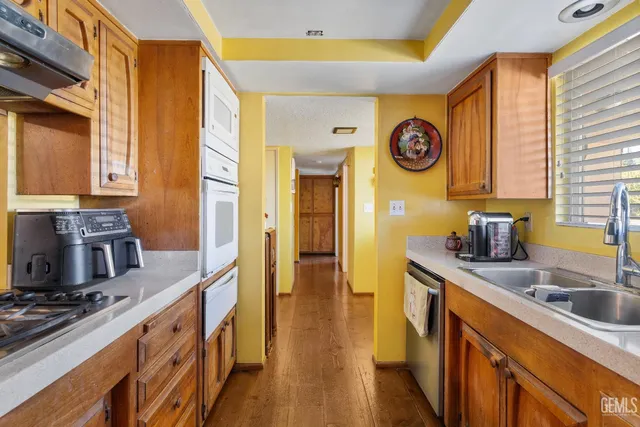 a kitchen with stainless steel appliances granite countertop a stove and a sink