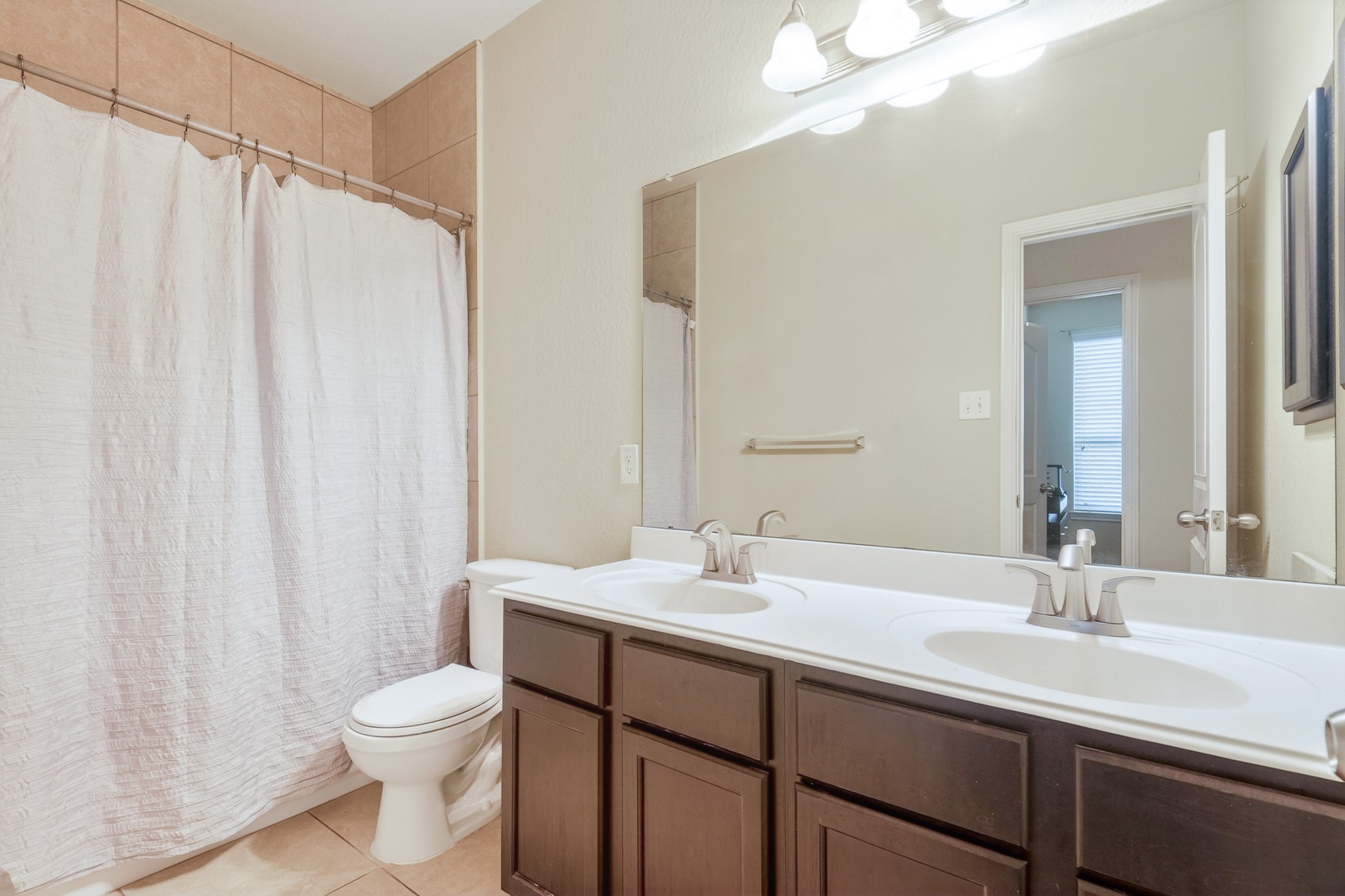 24711 East Burnaby Circle Spring, TX 77373 - Photo 18 of 20 a bathroom with a double vanity sink toilet and a mirror