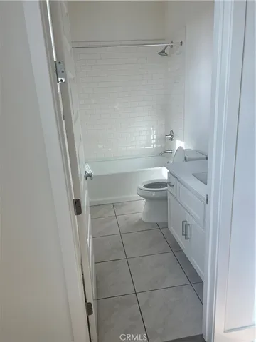 a bathroom with a granite countertop toilet and a shower
