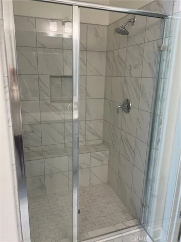 a bathroom with a glass door shower