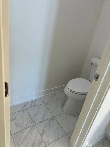a white toilet sitting next to a shower