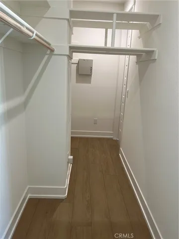 a view of walk in closet with empty racks