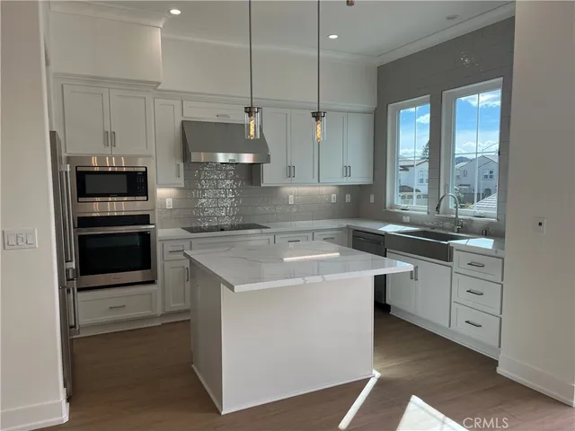 a kitchen with a sink stove and refrigerator