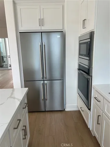 a kitchen with a refrigerator and a sink