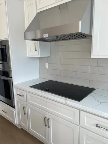 a close view of a stove a microwave and cabinets in the kitchen