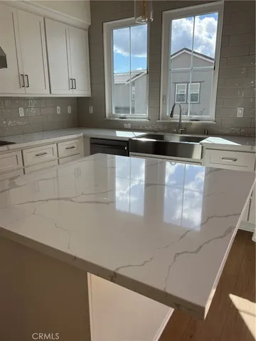 a kitchen with stainless steel appliances a sink and cabinets