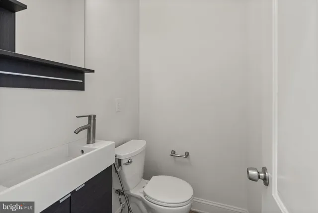 a white toilet sitting next to a bathroom sink