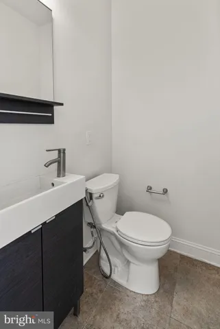 a white toilet sitting next to a bathroom sink