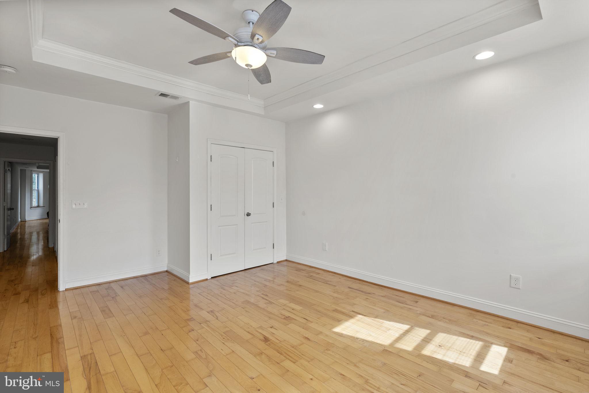 722 Lennox Street Baltimore, MD 21217 - Photo 22 of 52 an empty room with a ceiling fan and a window