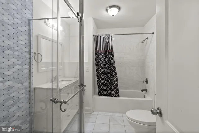 a bathroom with a shower a toilet and shower