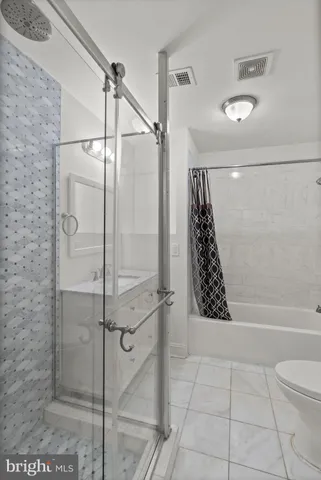a bathroom with a shower and a glass door
