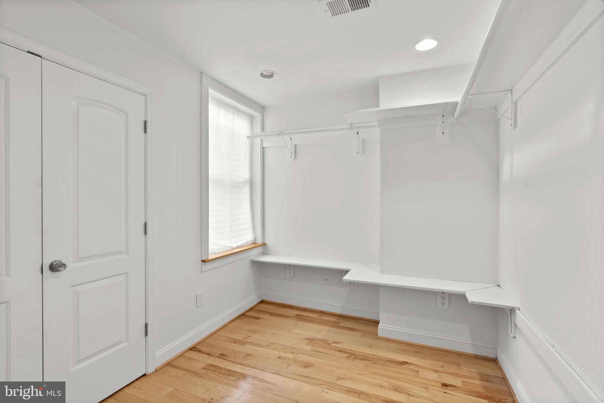 722 Lennox Street Baltimore, MD 21217 - Photo 27 of 52 a view of an empty room with wooden floor and a window