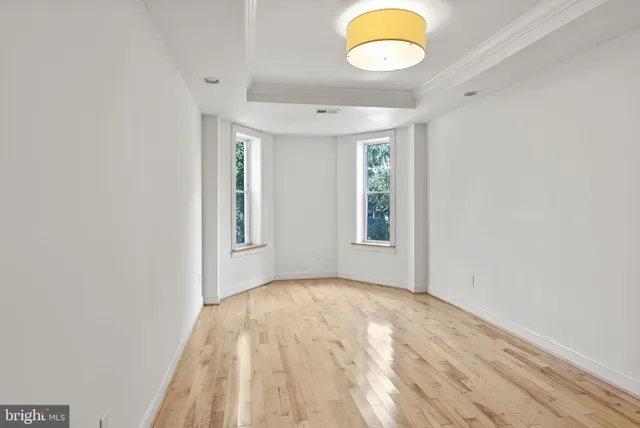 wooden floor in an empty room with a window
