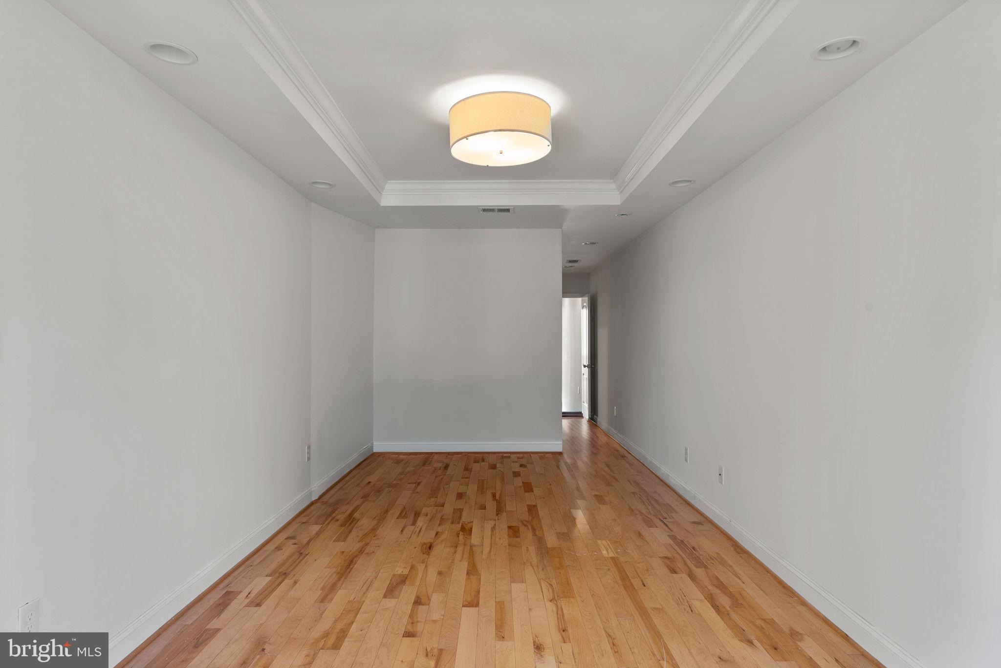 722 Lennox Street Baltimore, MD 21217 - Photo 31 of 52 a view of a room with wooden floor and a window
