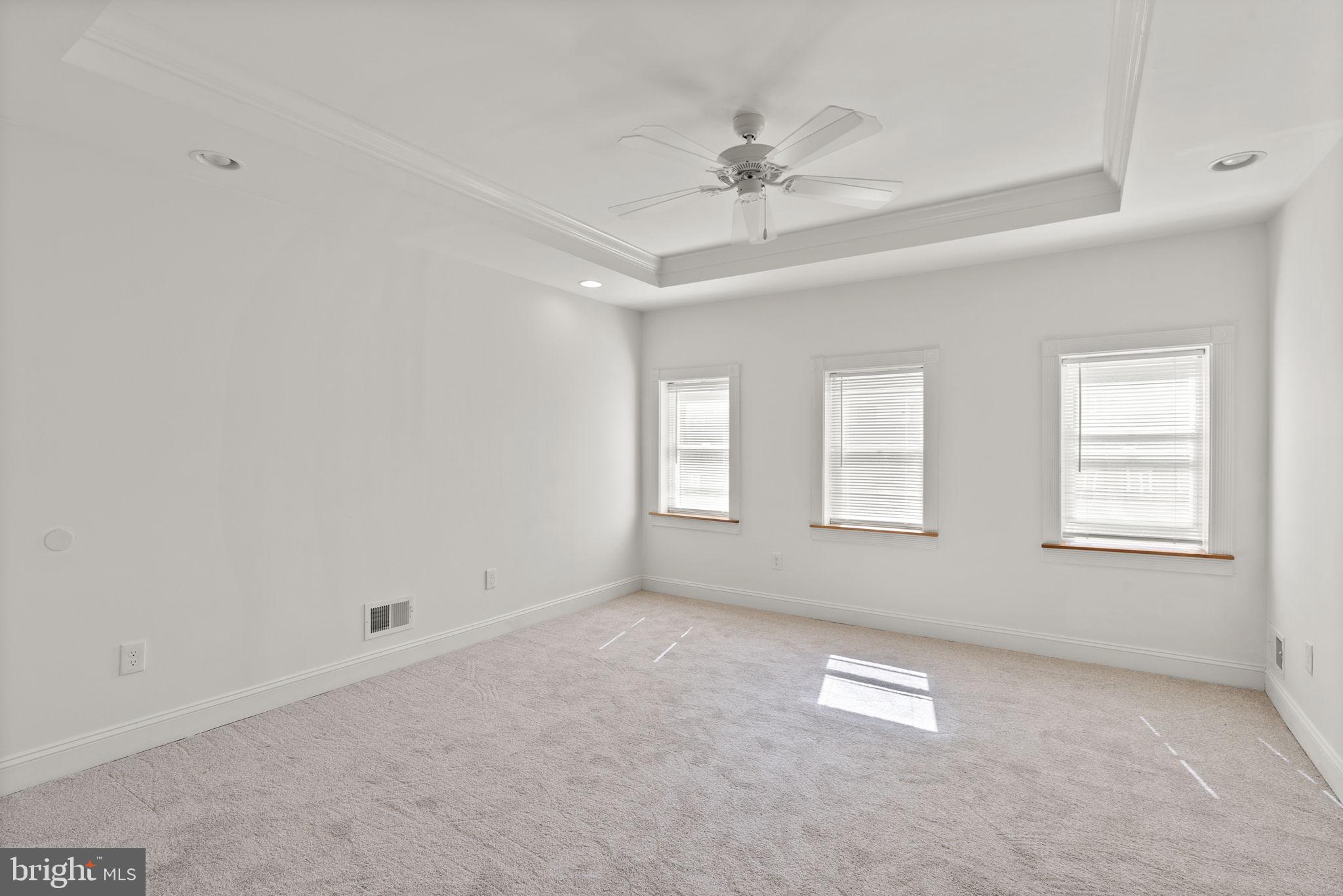 722 Lennox Street Baltimore, MD 21217 - Photo 32 of 52 an empty room with windows and fan